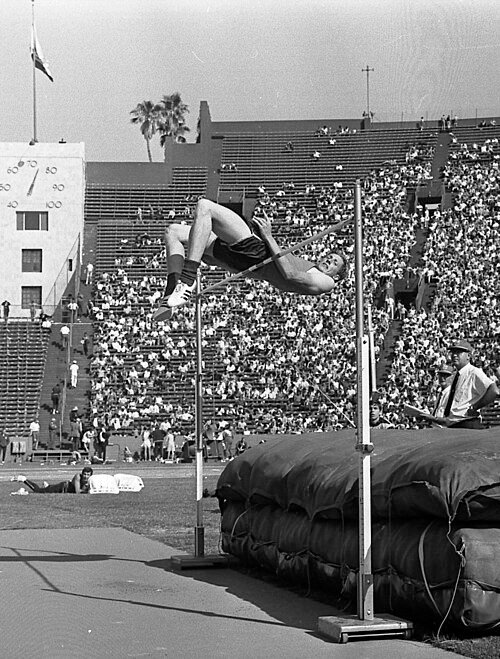 Dick Fosbury clearing the bar using the Fosbury Flop technique during competition.